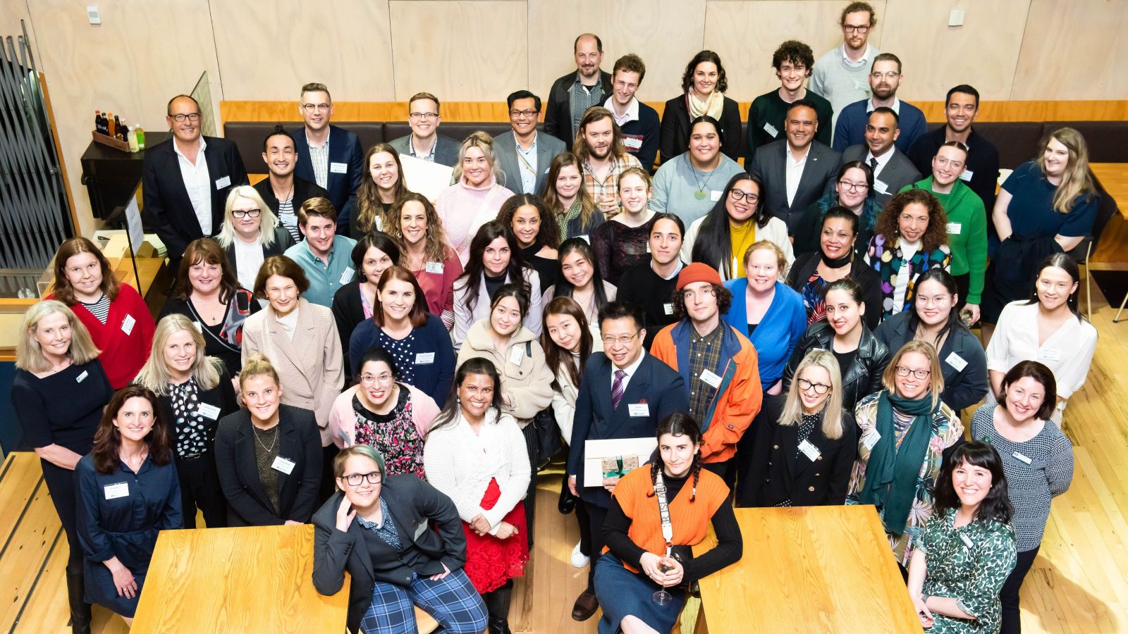 Group of 50 people smiling up at the camera