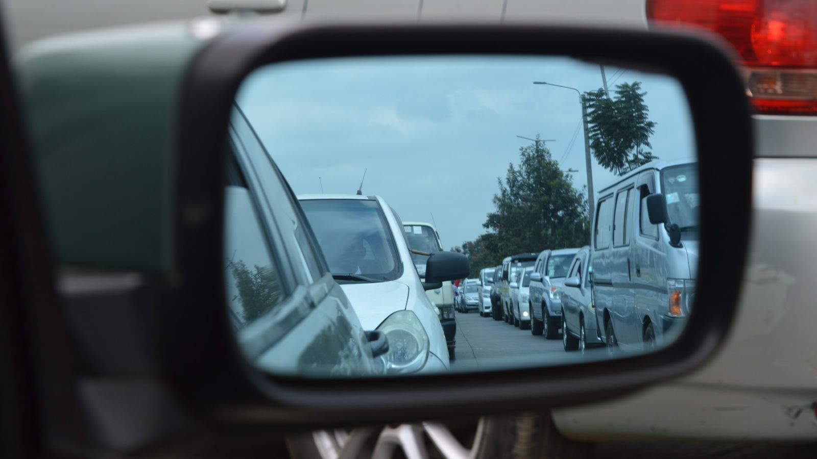 Traffic jam seen through car mirror