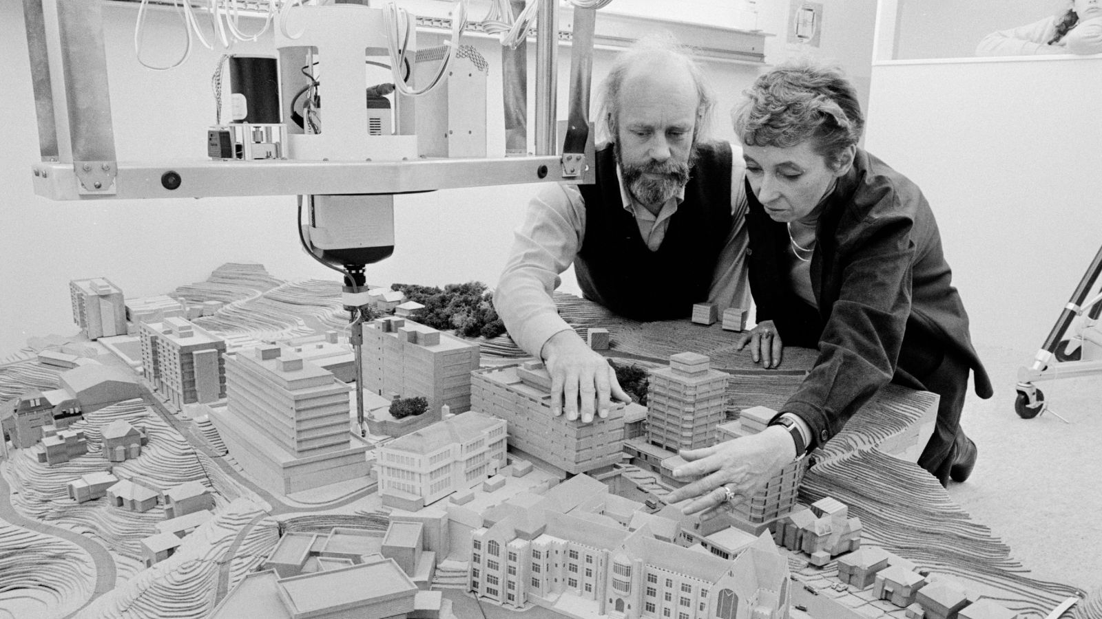 Helen Tippett and David Reed looking over an architectural model 