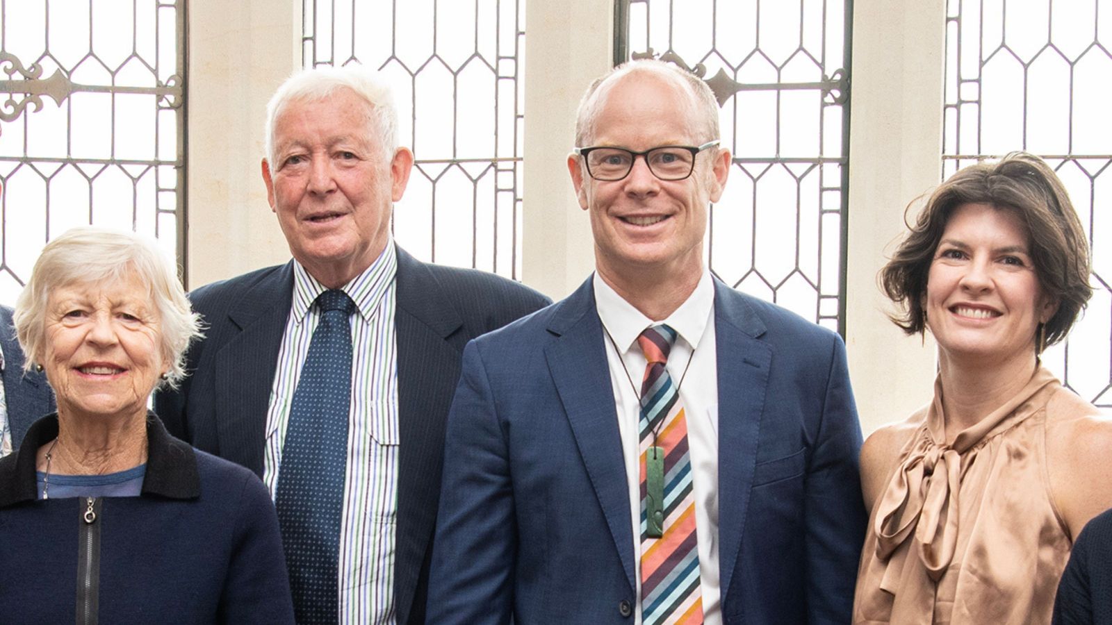 four people wearing formal clothes, two women and two men