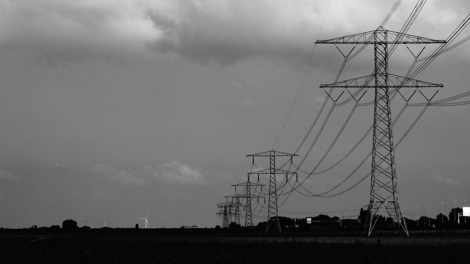 Power pylons against a grey sky 