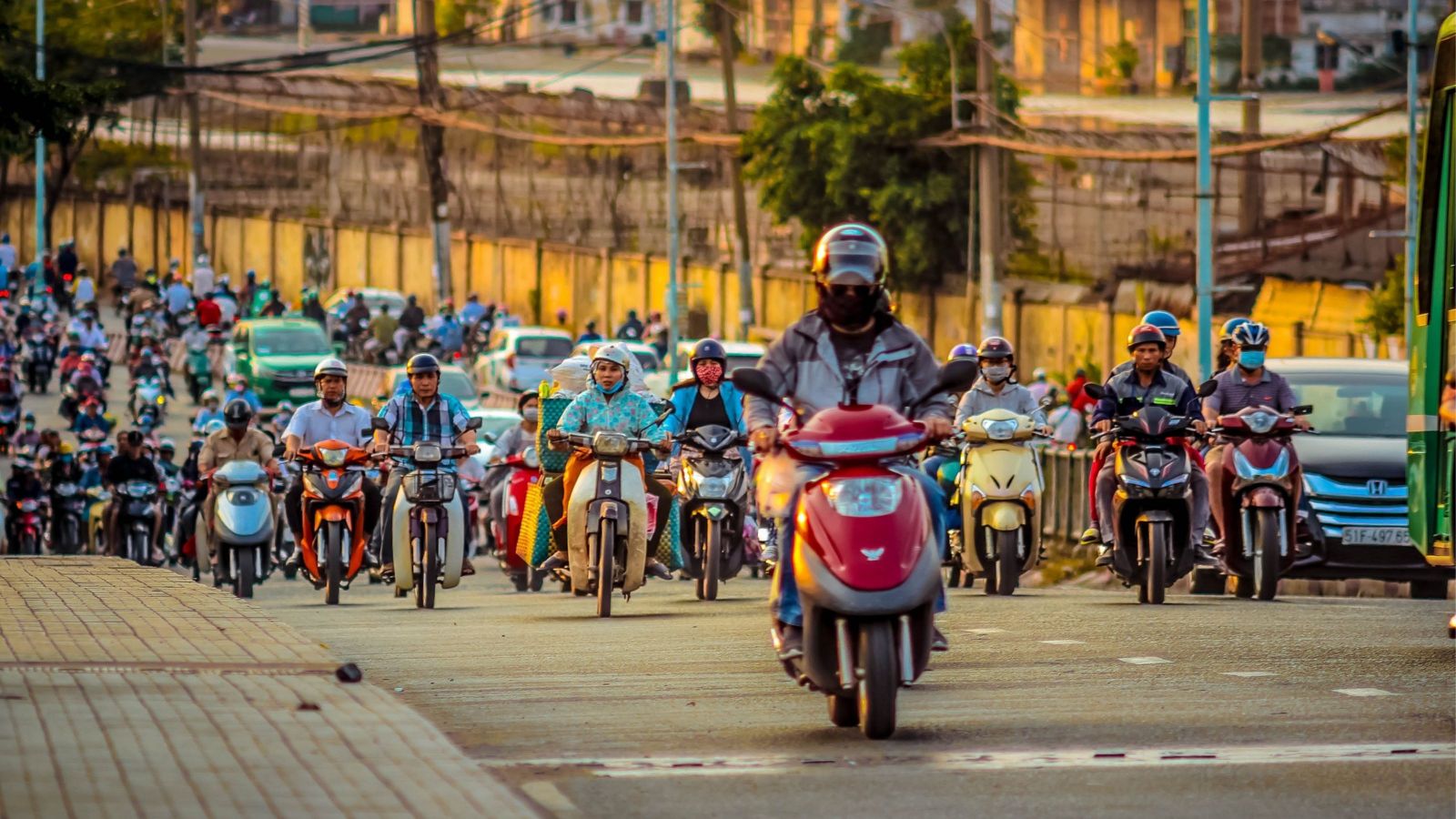 group of people on scooters travelling on road