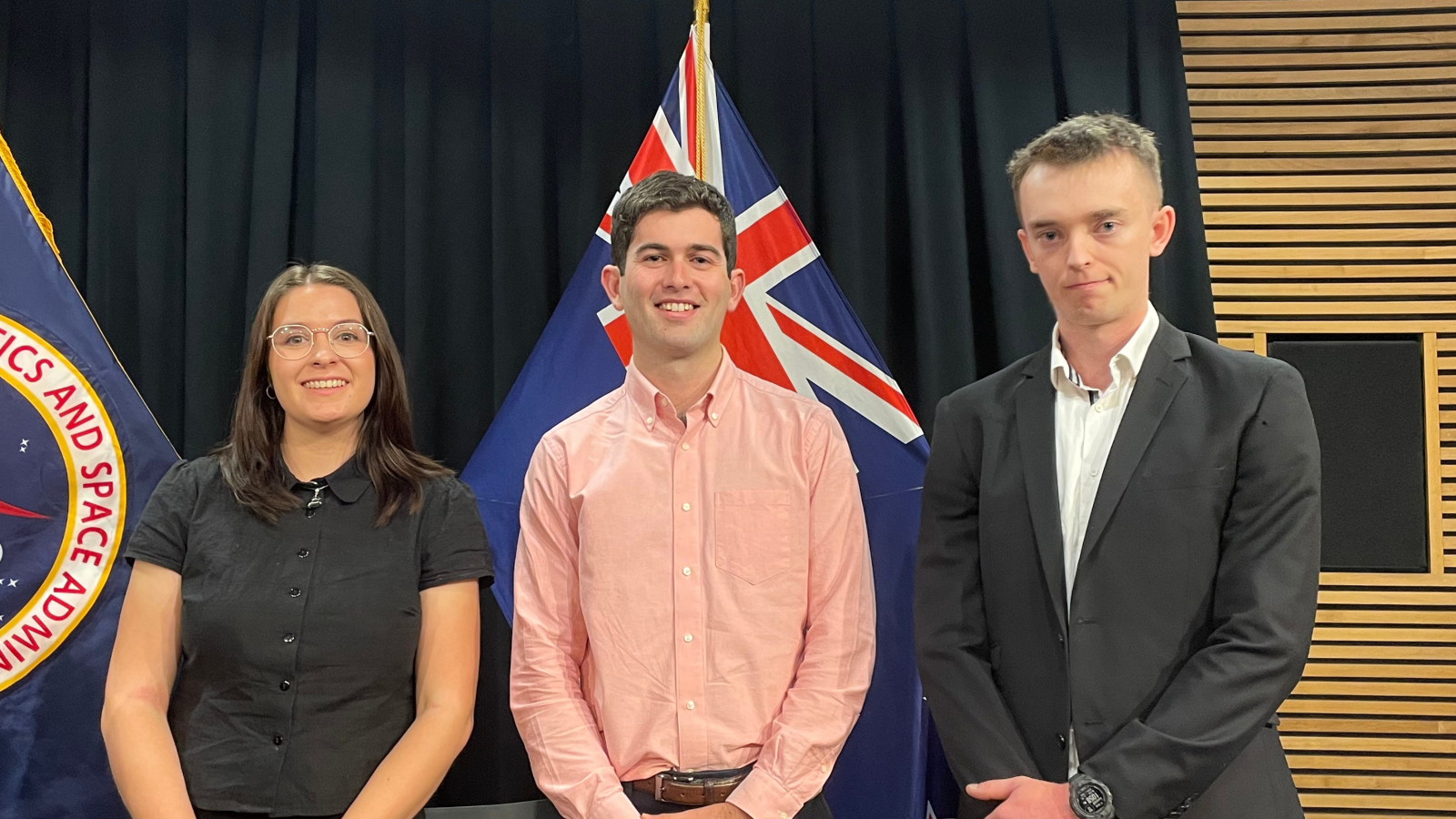 A group of young people stand in the New Zealand Parliament buildings.