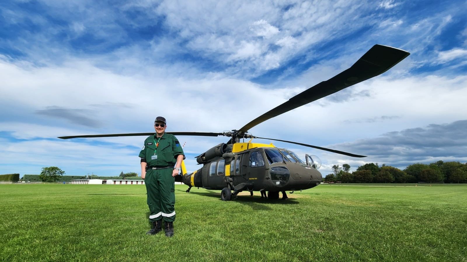 Man standing in front of helicopter.
