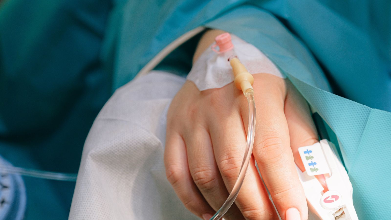Patient in hospital bed with IV drip