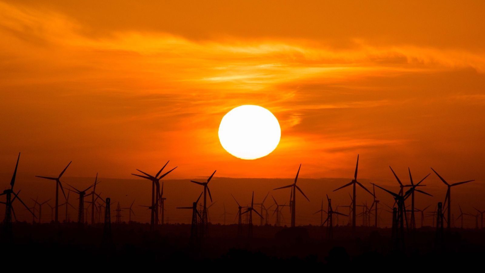 Wind turbines against a setting sun