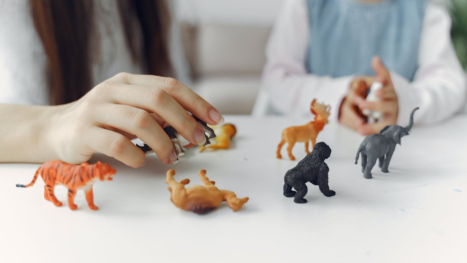 Two children playing with toy animals