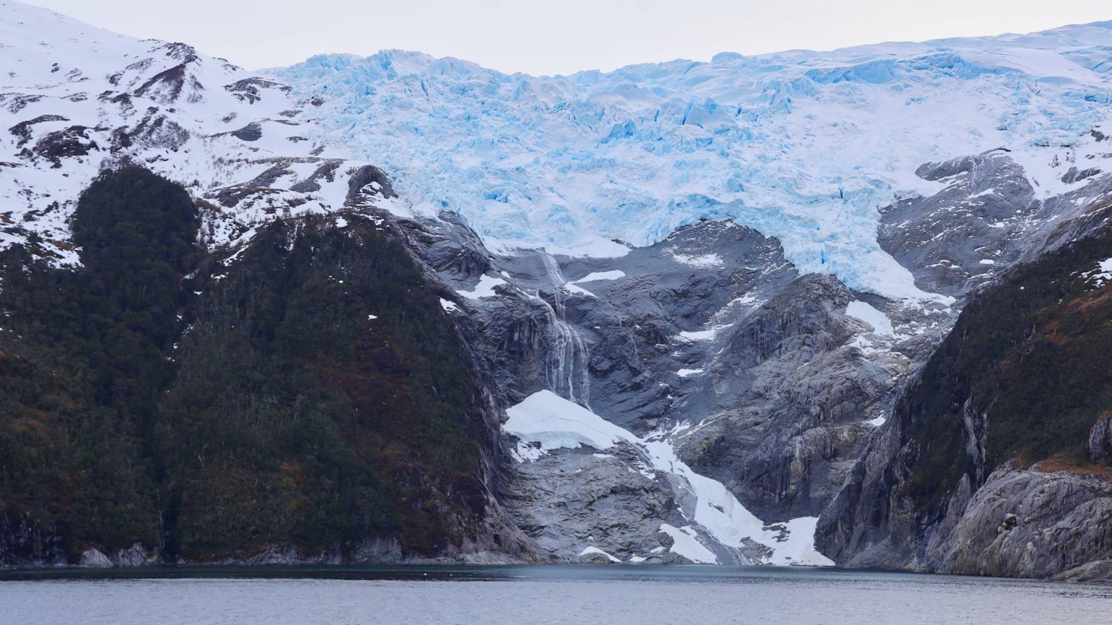 Snow-covered mountain near ocean
