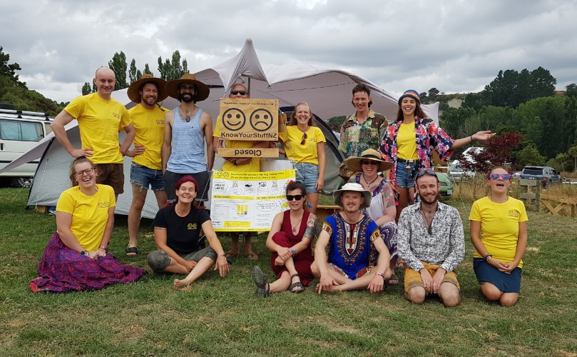 Group of people with sign posing for photo
