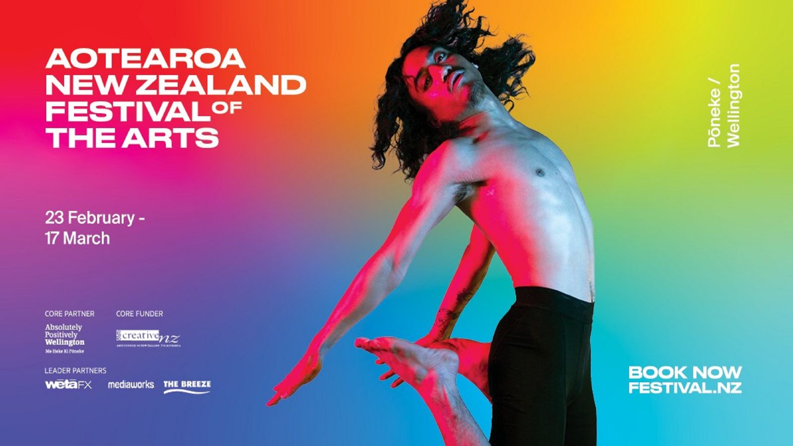  NZ Festival of Arts banner with bright coloured background and a person with long hair and black pants dancing