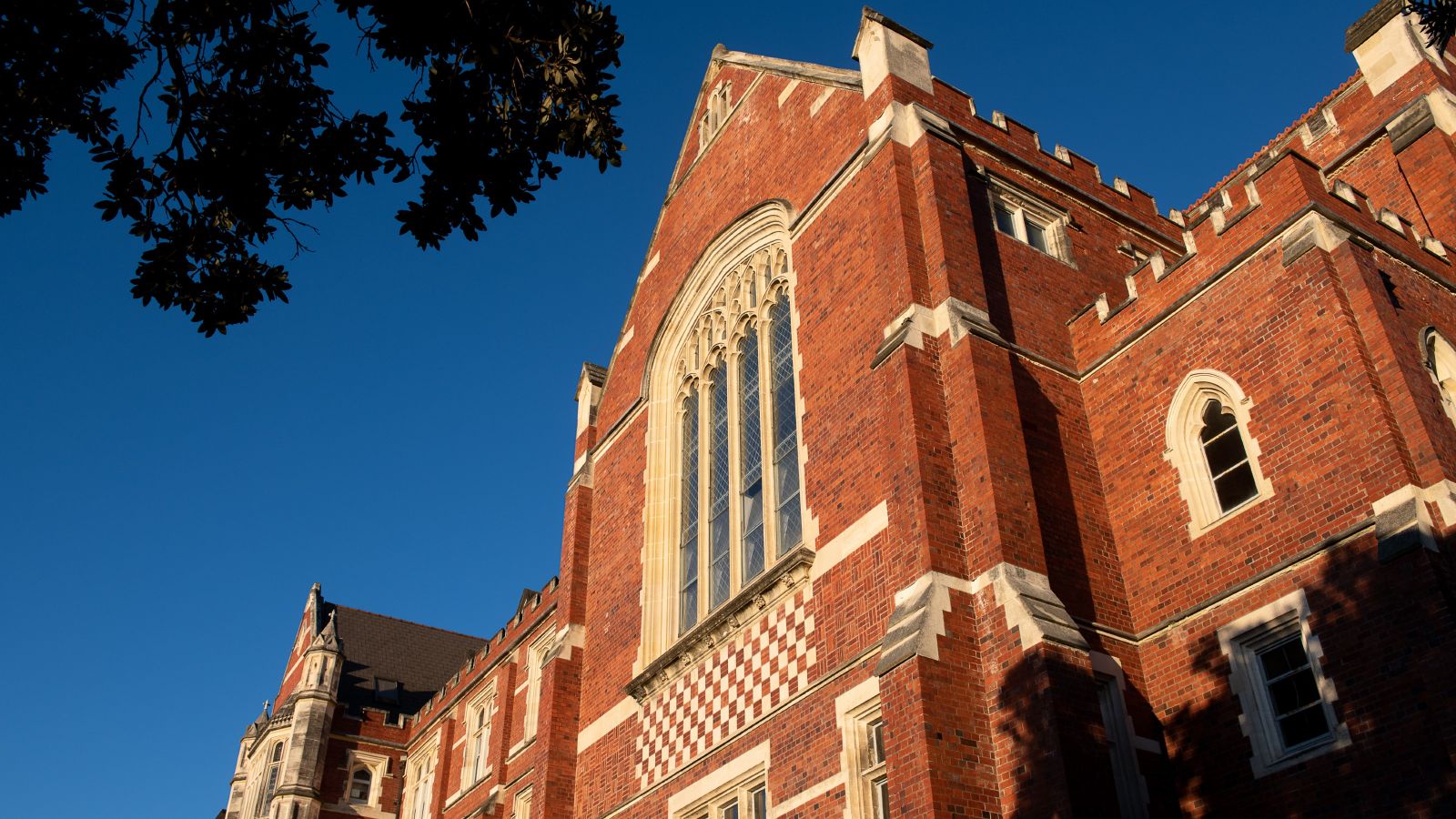 The brick and gothic style Hunter Building on Kelburn Campus, caught in midday sun