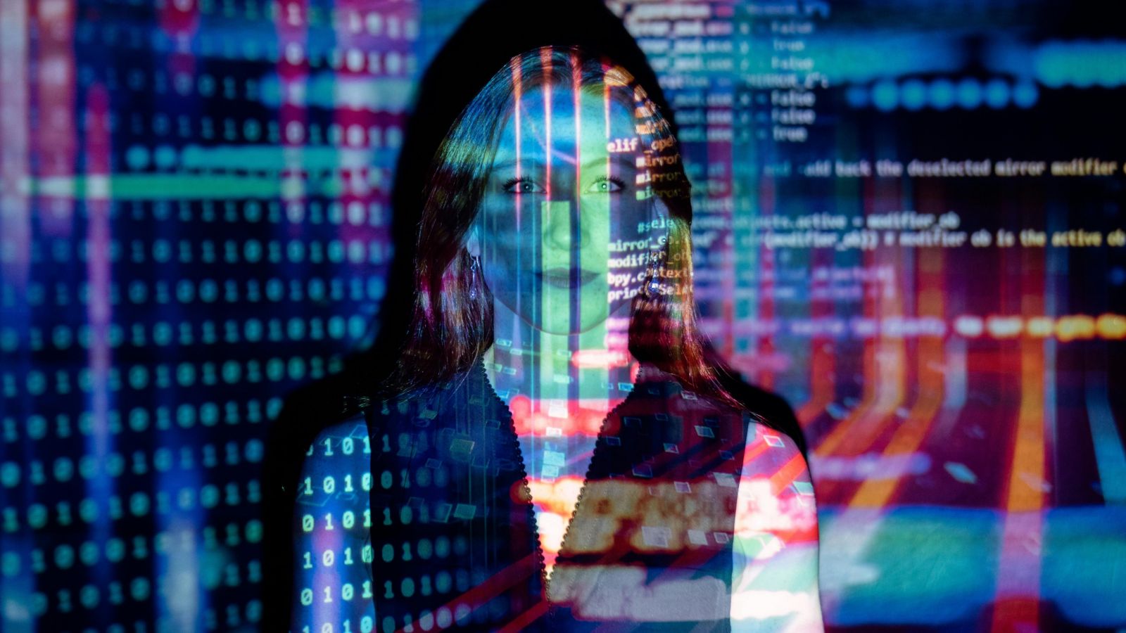 Computer code projected on person's face 