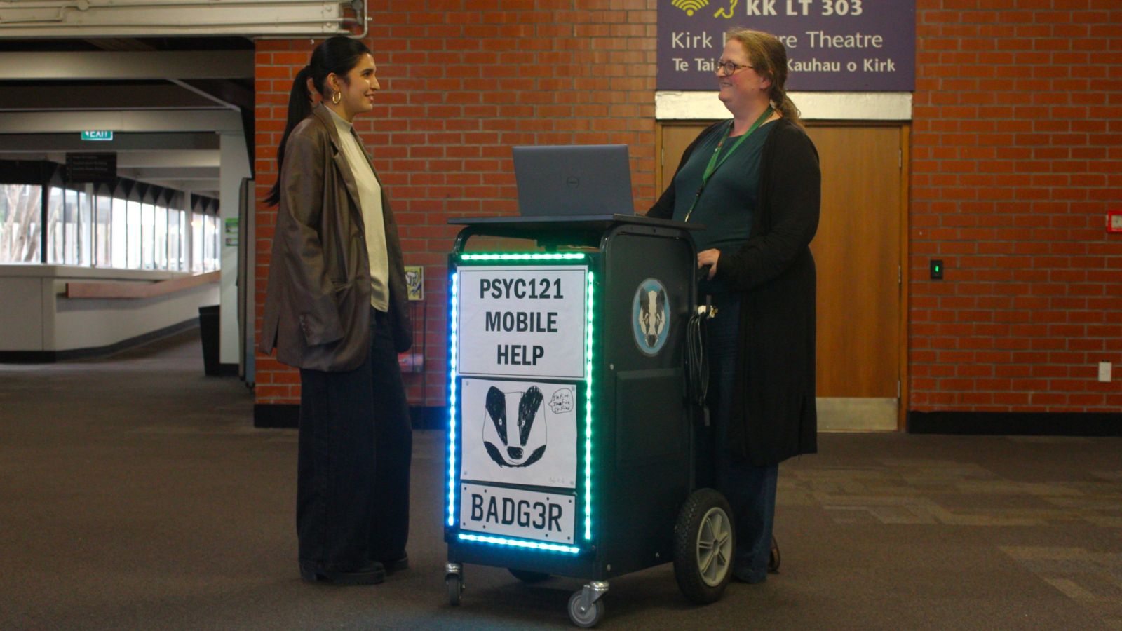 Dr Tash Buist stands behind the LED lit up Badger Card with a student she is helping