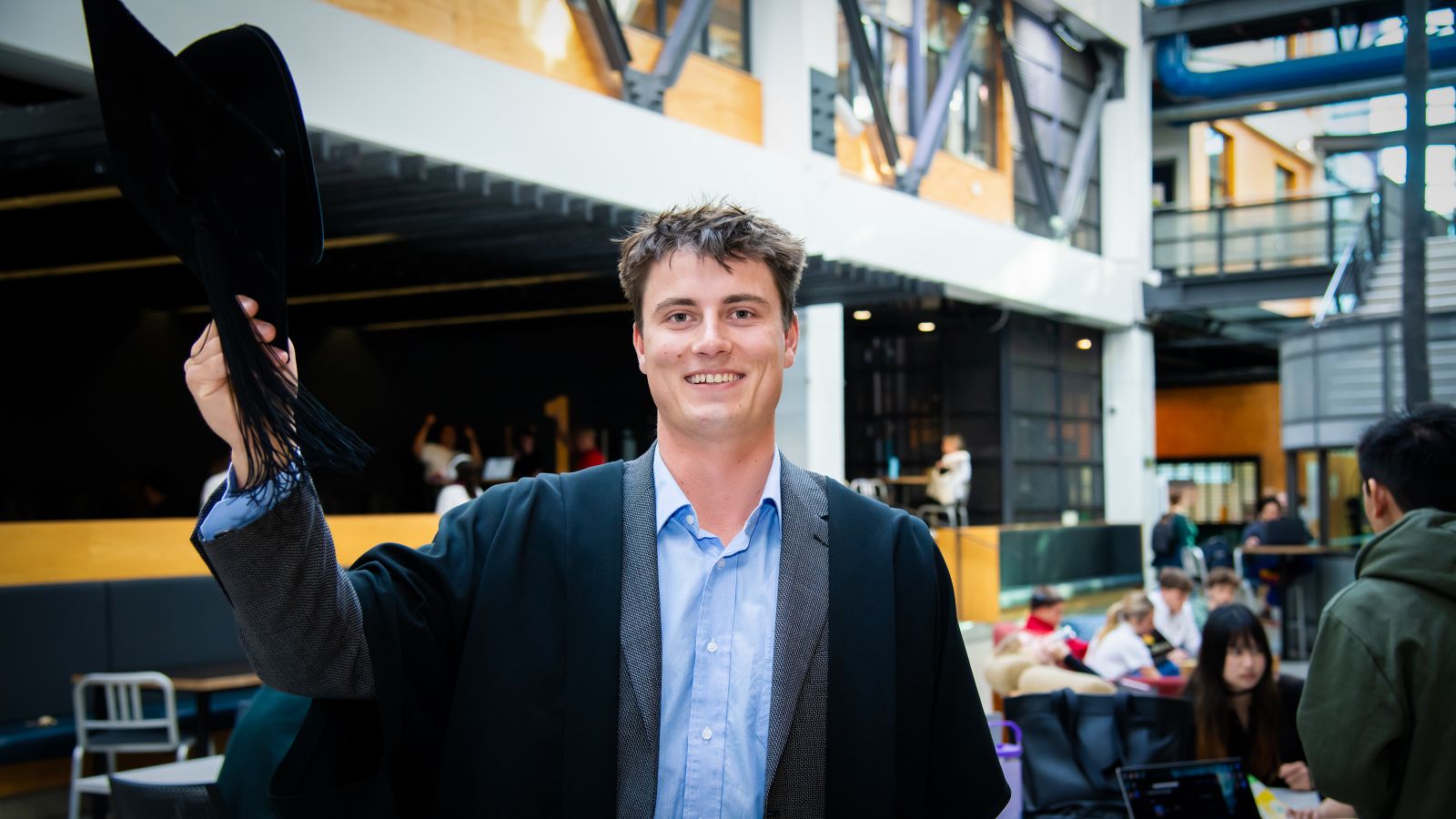 Henry McIntyre in graduation gear inside the Te Aro campus