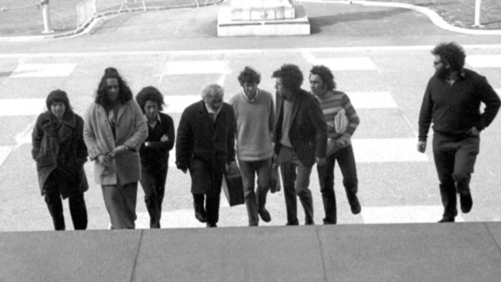 Eight people coming up stairs