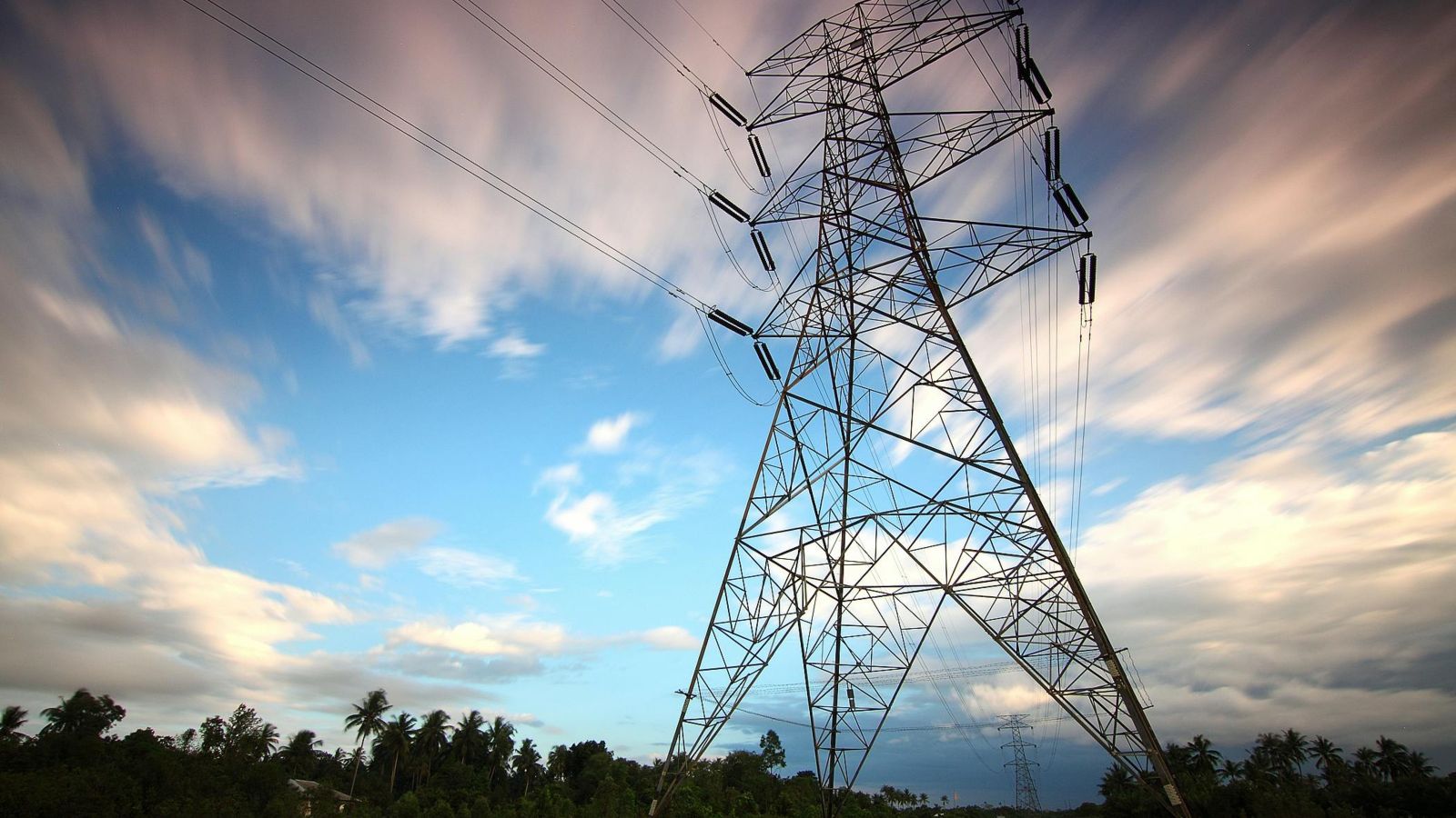 Power pylon with clouds above 