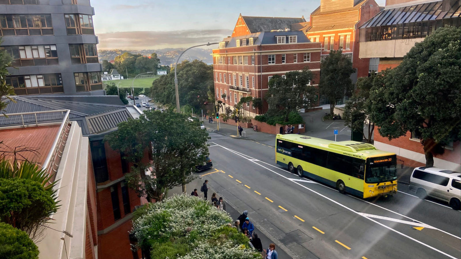 A view of Kelburn parade showing university buildings and a bus