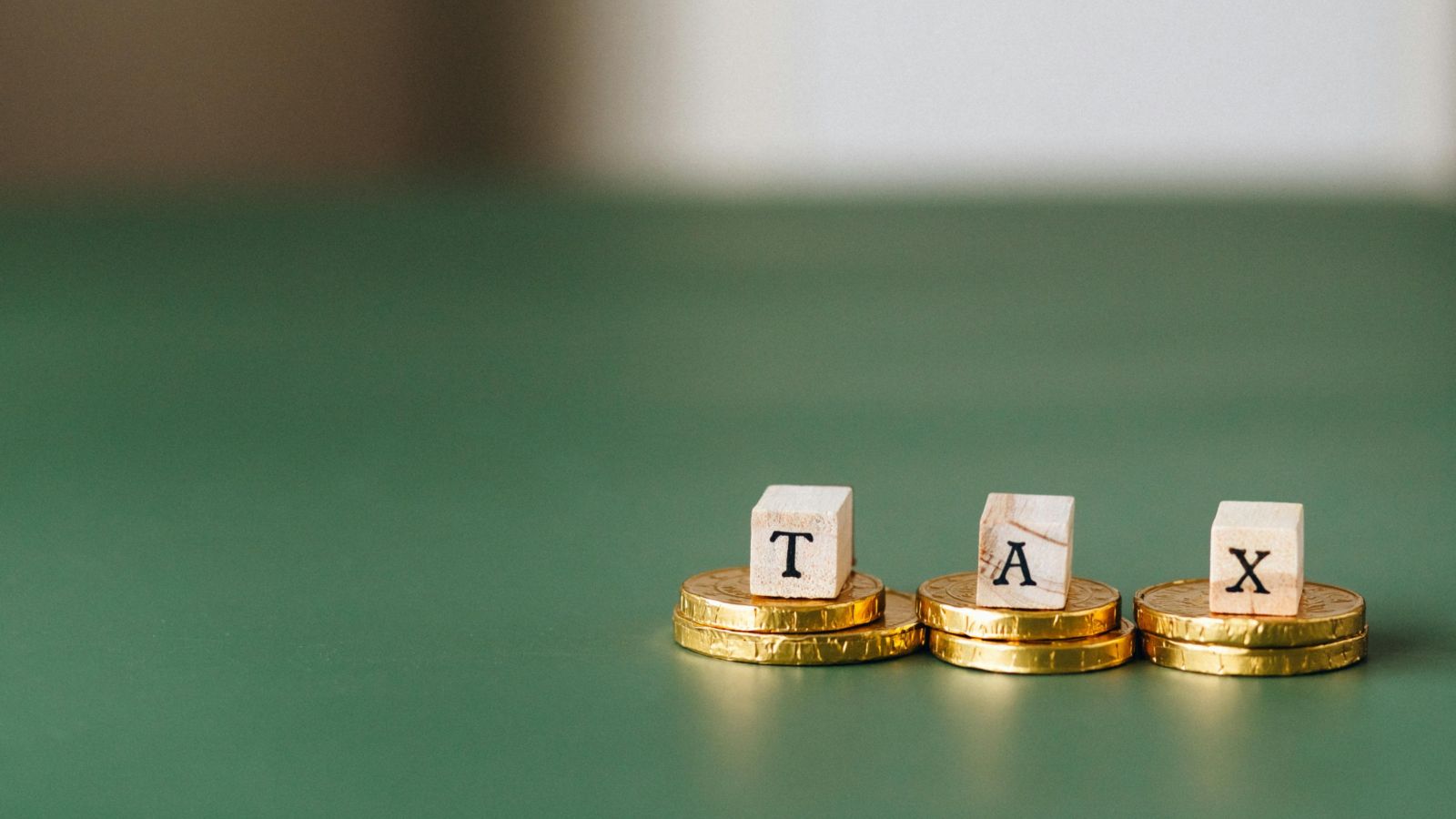 The word 'tax' on wooden tiles 