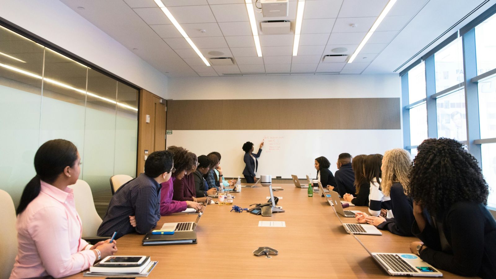 People sitting around a boardroom table 