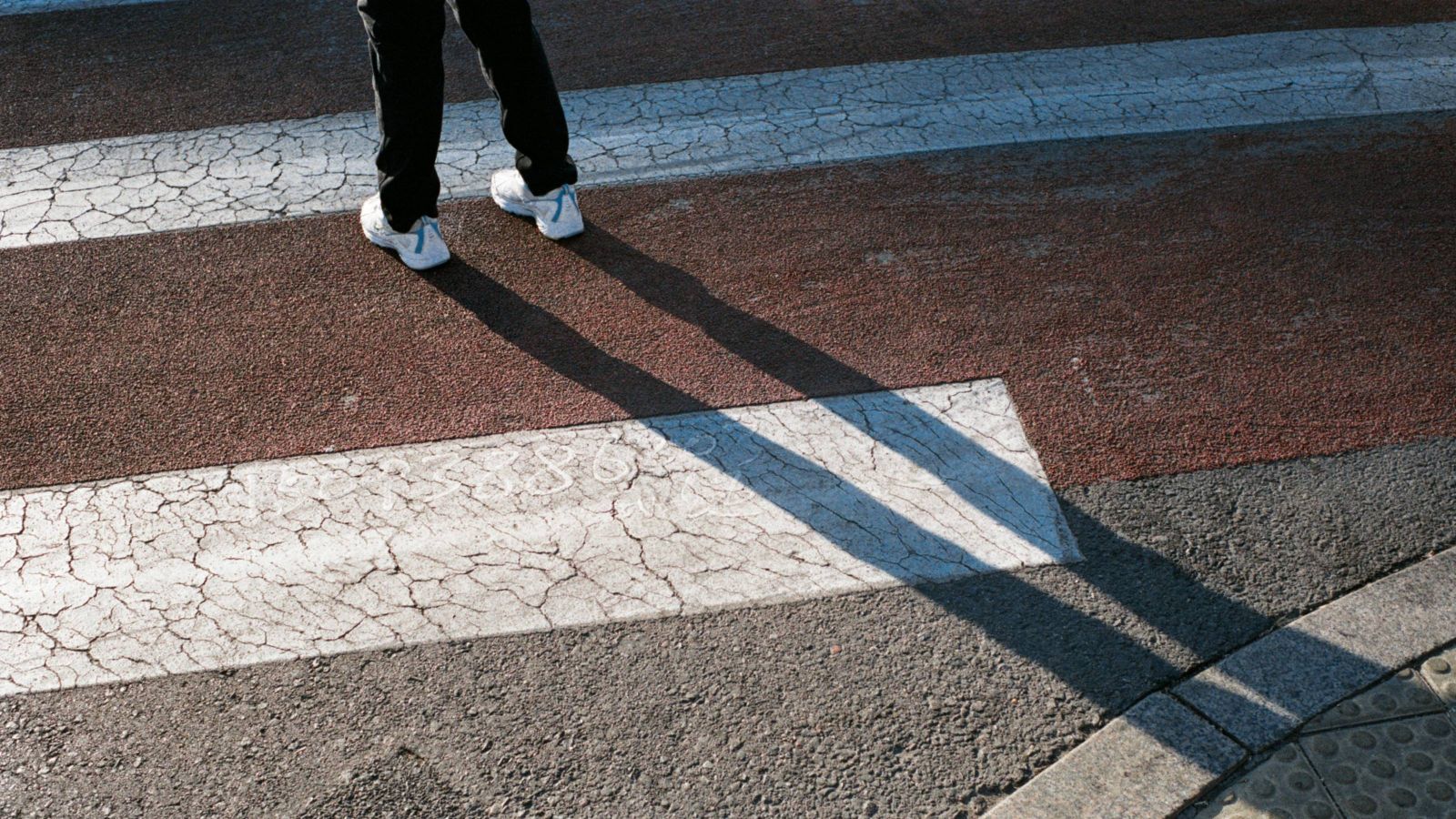 Person standing at pedestrian crossing 