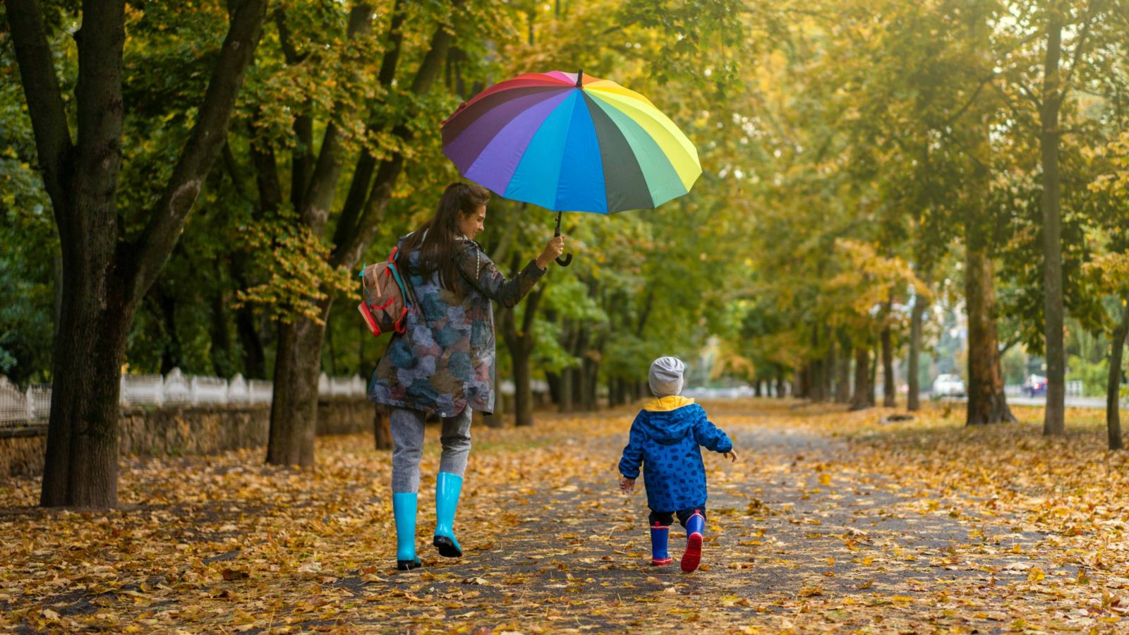 Woman and child walking in park 