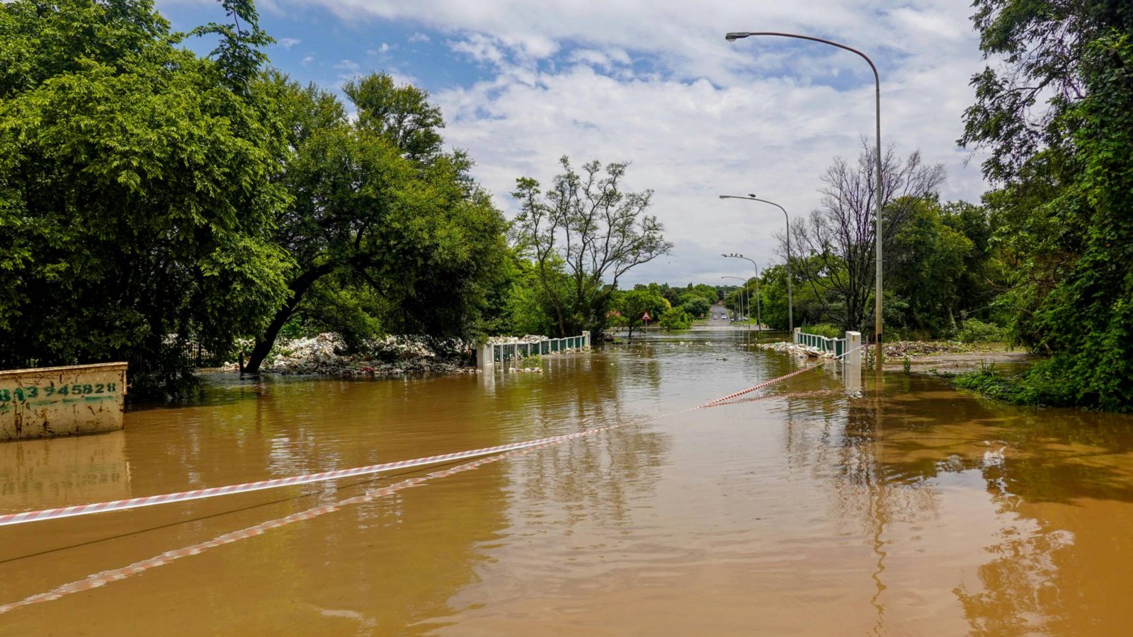Flooded road with water flowing over a bridge 
