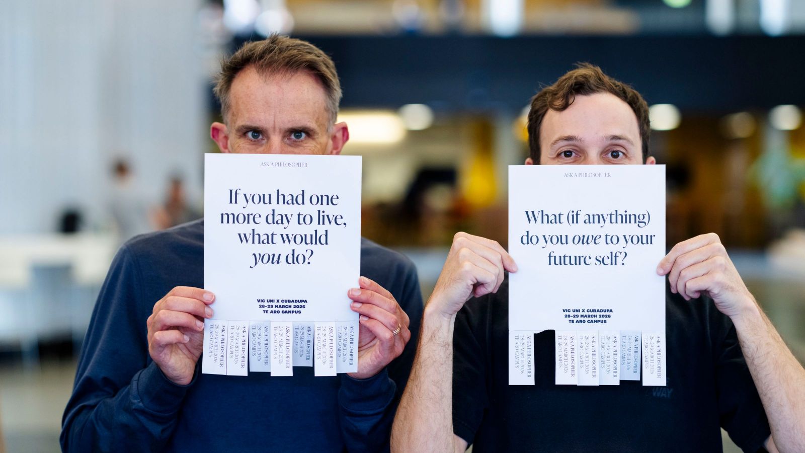 two men holding up philosophical questions in front of their faces