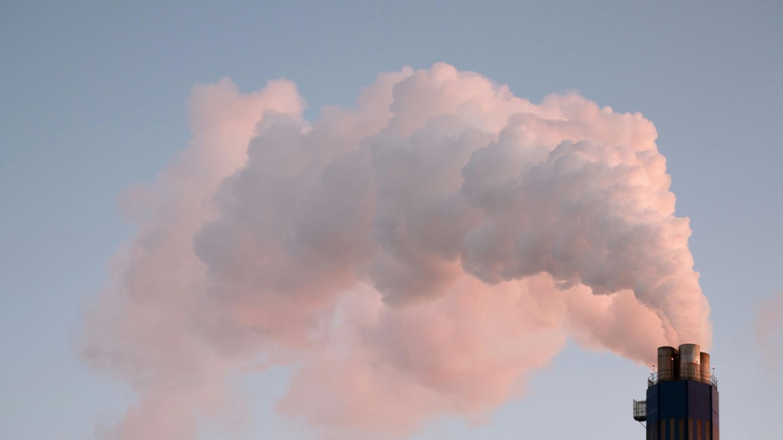 Smoke rising into the air from an industrial chimney 