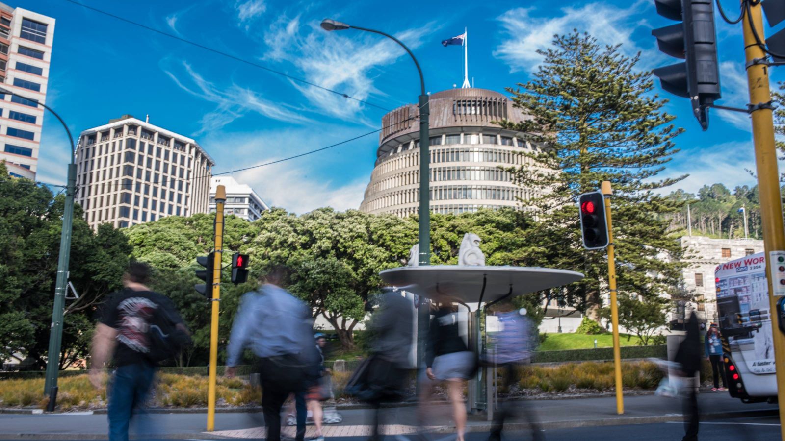Commuters walking past the Beehive building in Wellington