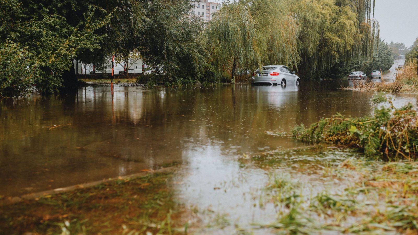 Flooded street with car in background 