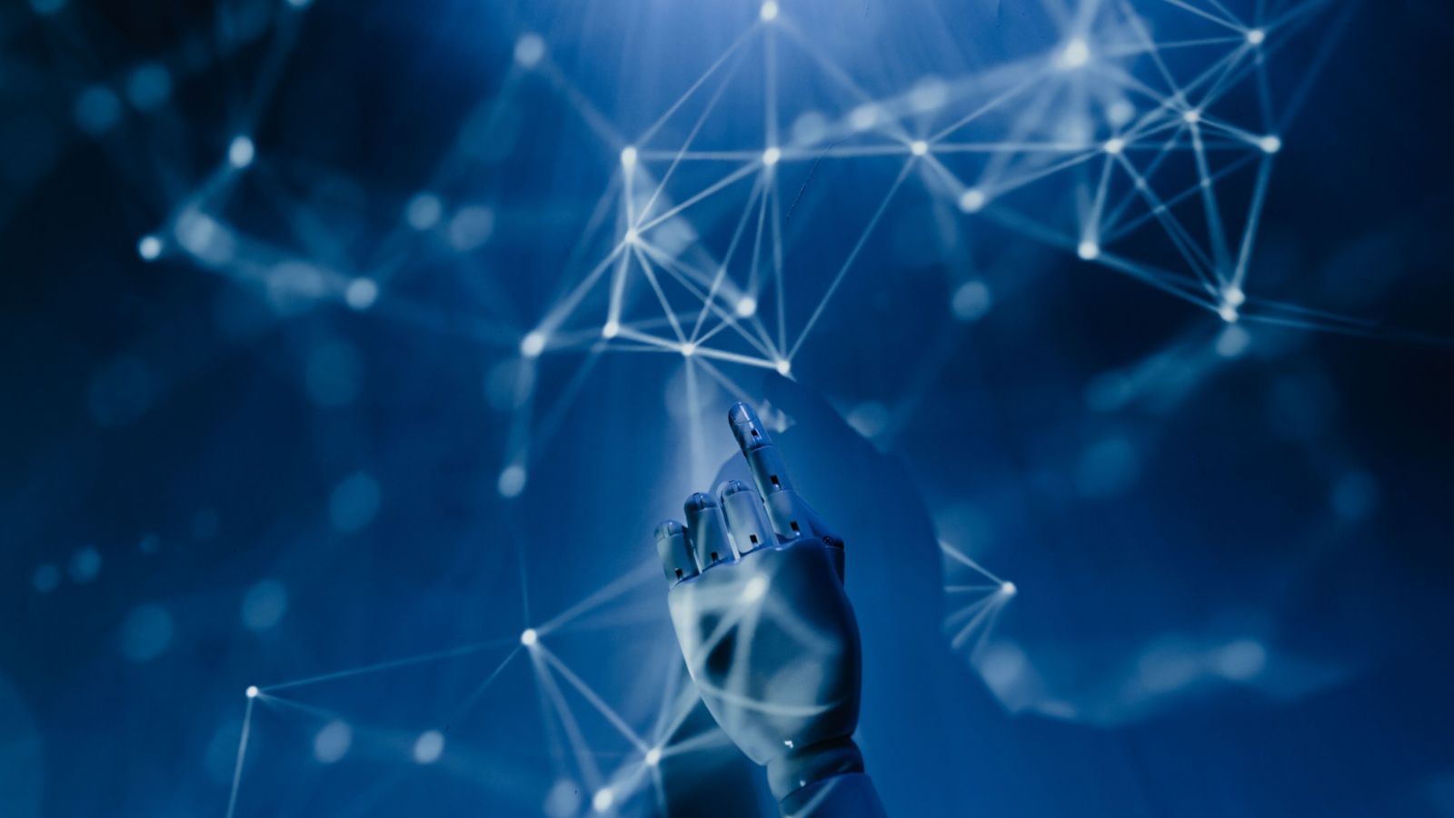 A robotic hand reaching into a digital network, symbolising AI 