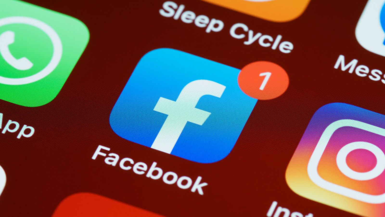 A close-up of social media app icons on a smartphone screen