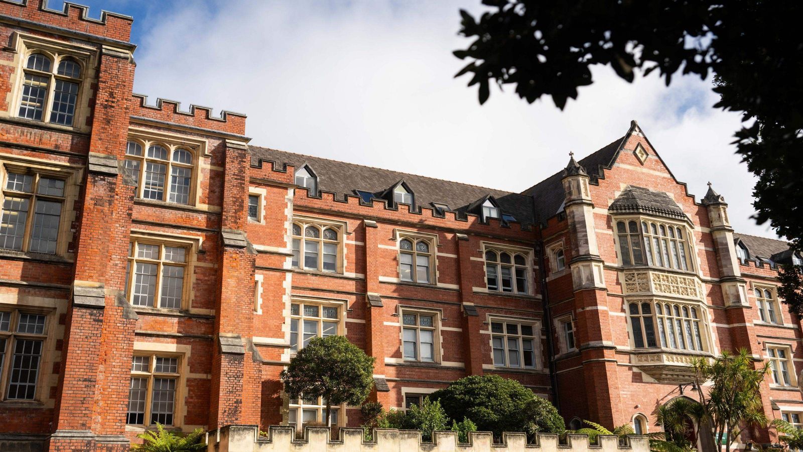 red brick building with white brick trim, with crenellated frontage