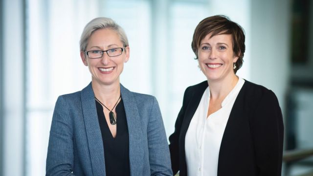 Caz Helen and Helen Rook are standing side by side, in professional atire, infront of a white background.