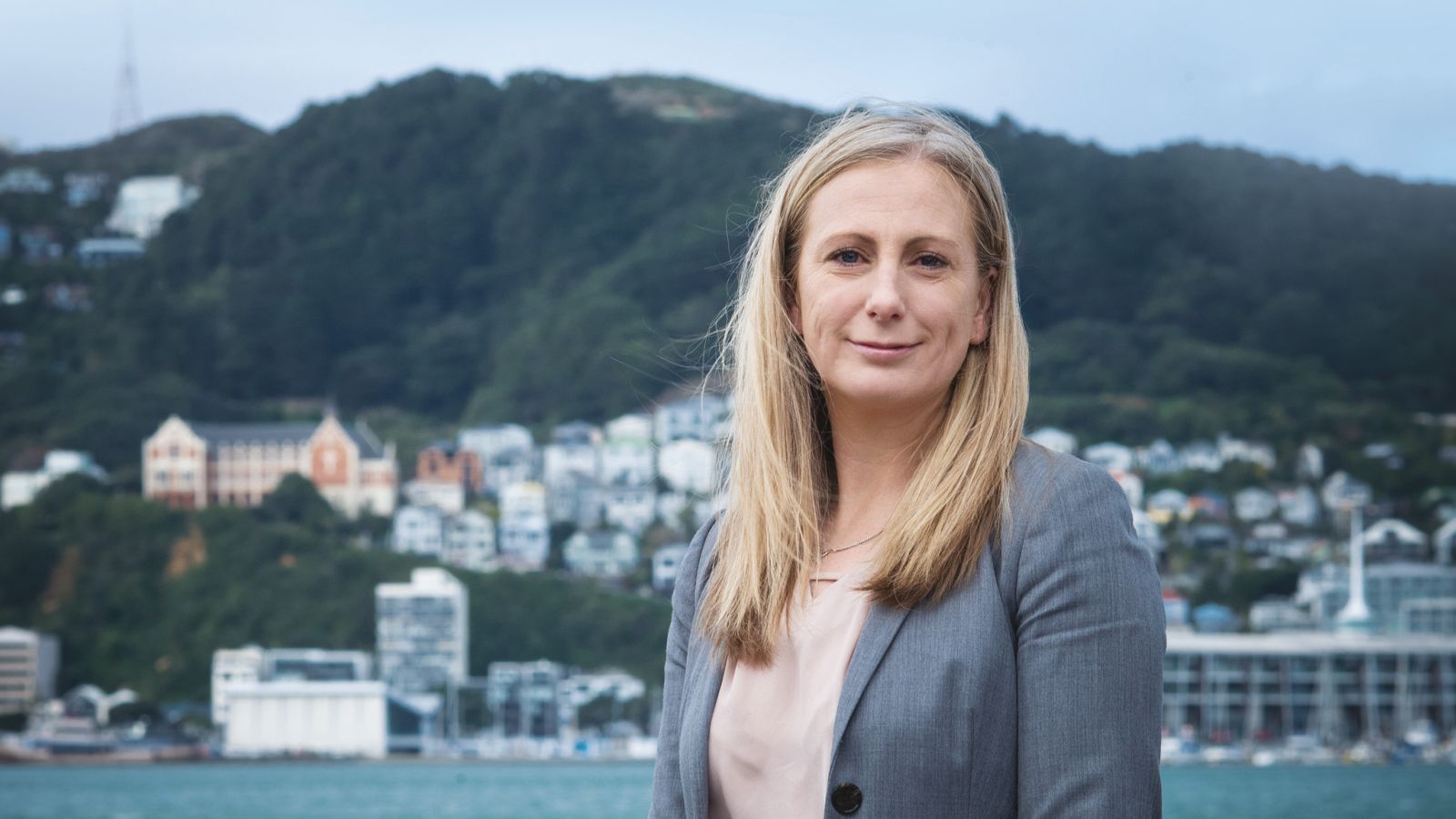 Kate Prickett stands by the shore with Wellington in the background.