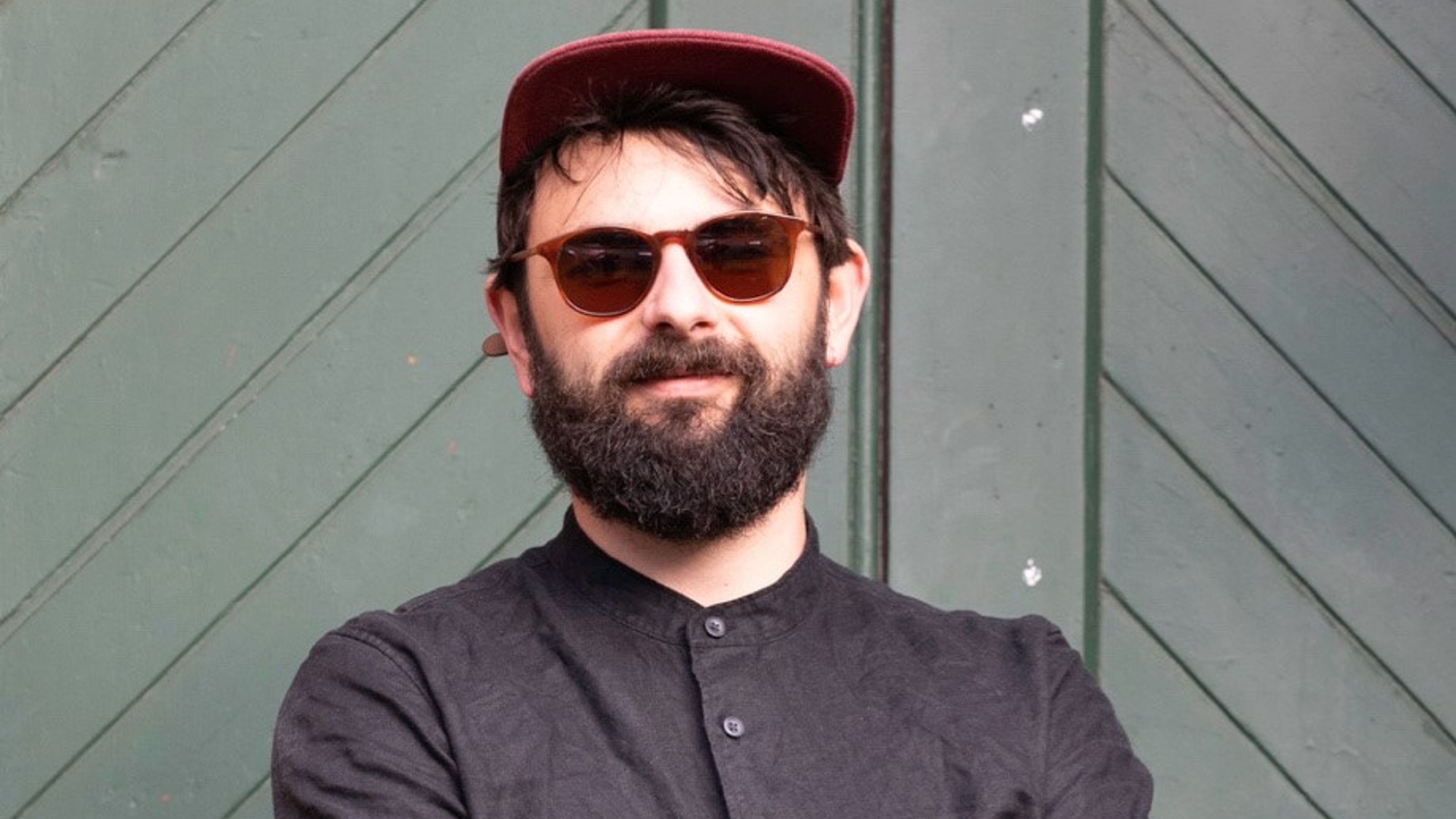 Portrait of person with sunglasses and hat 