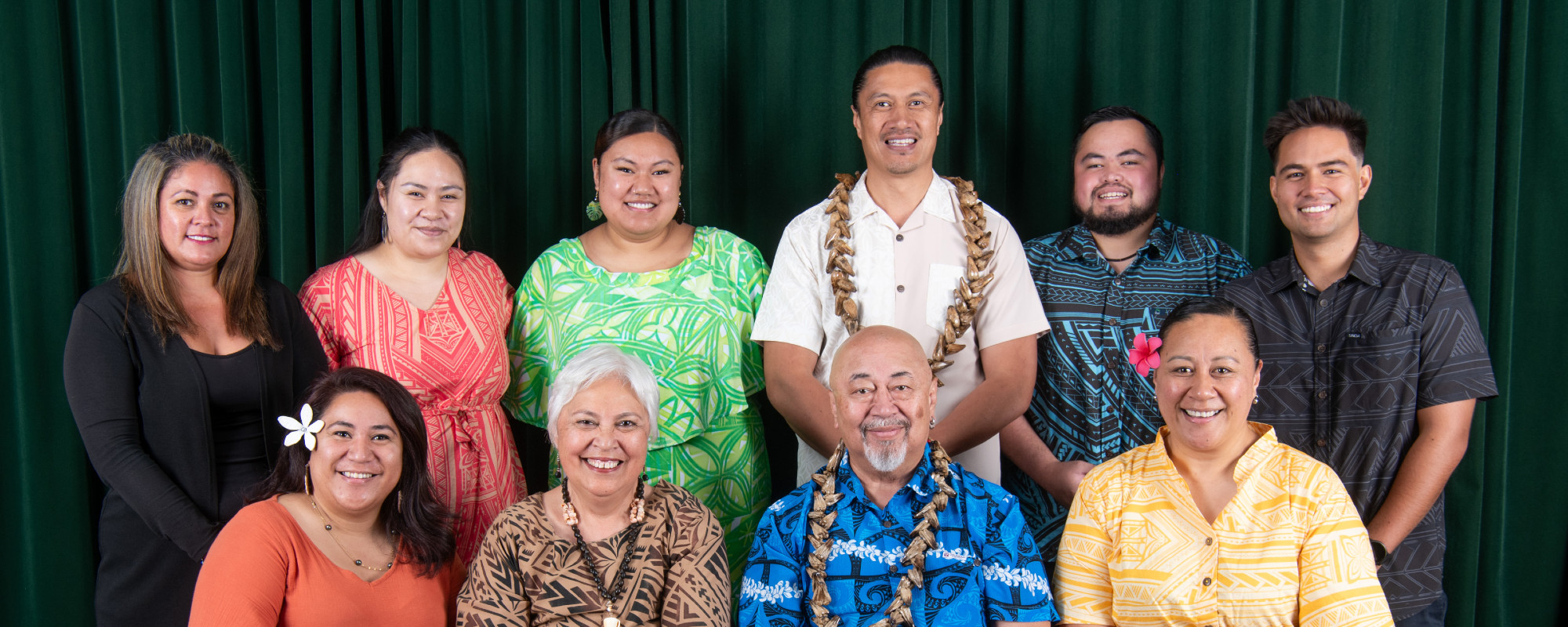 Ten members of the Pasifika team in two rows, smiling for the camera