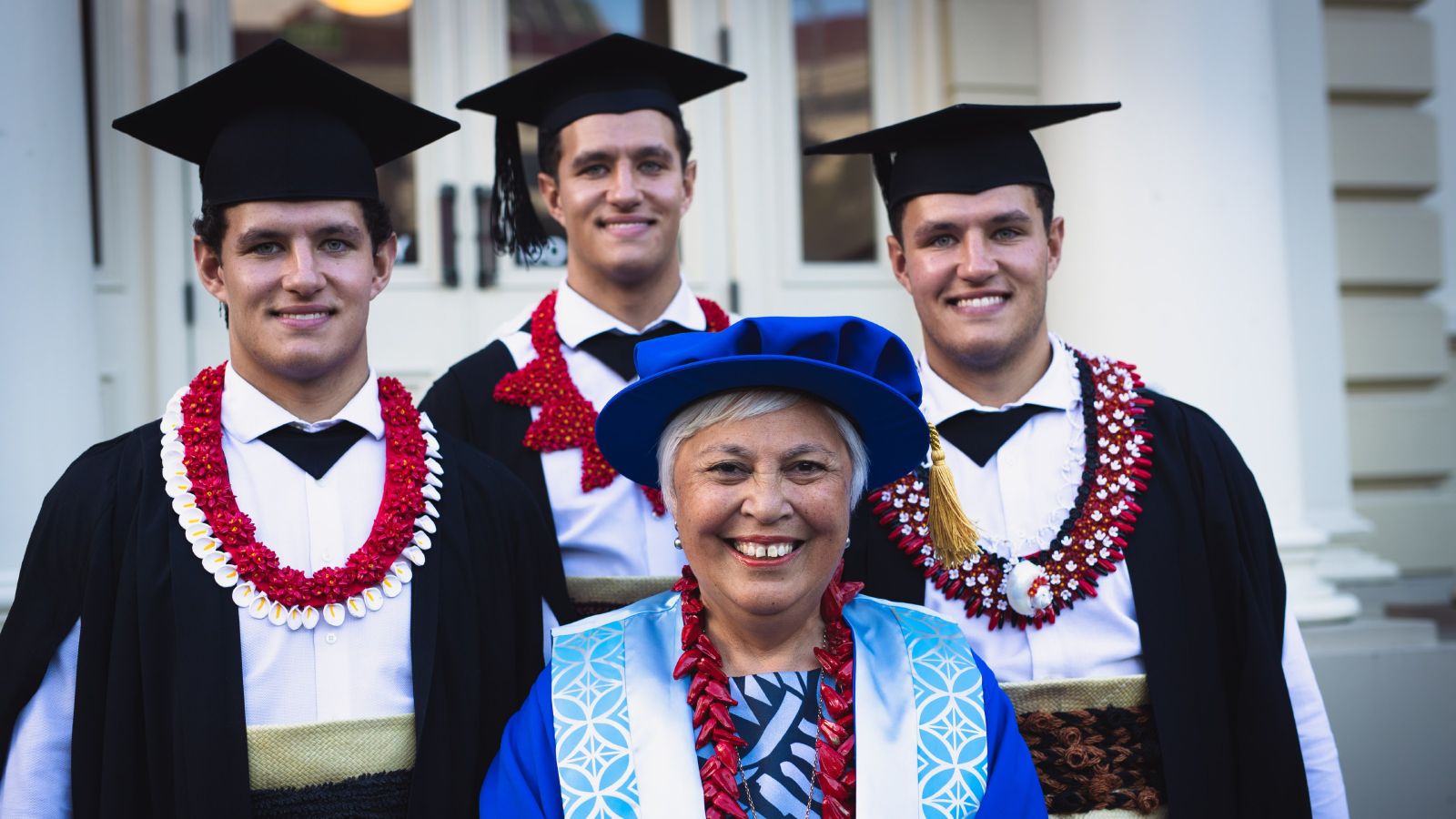Winnie Laban, dressed in blue, flanked by the Tongan triplets graduating in law.