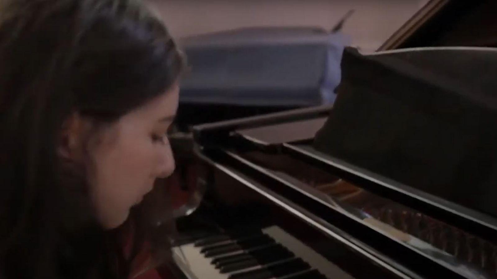 Jasmine seated at a piano.