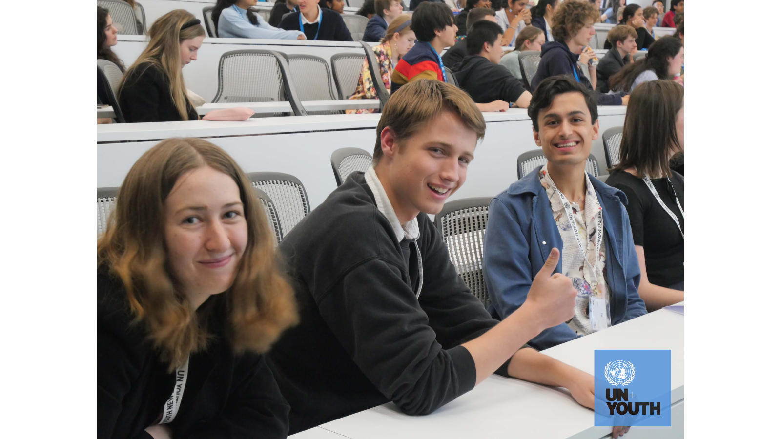 3 students of UN Youth posing for a photo at a conference meeting