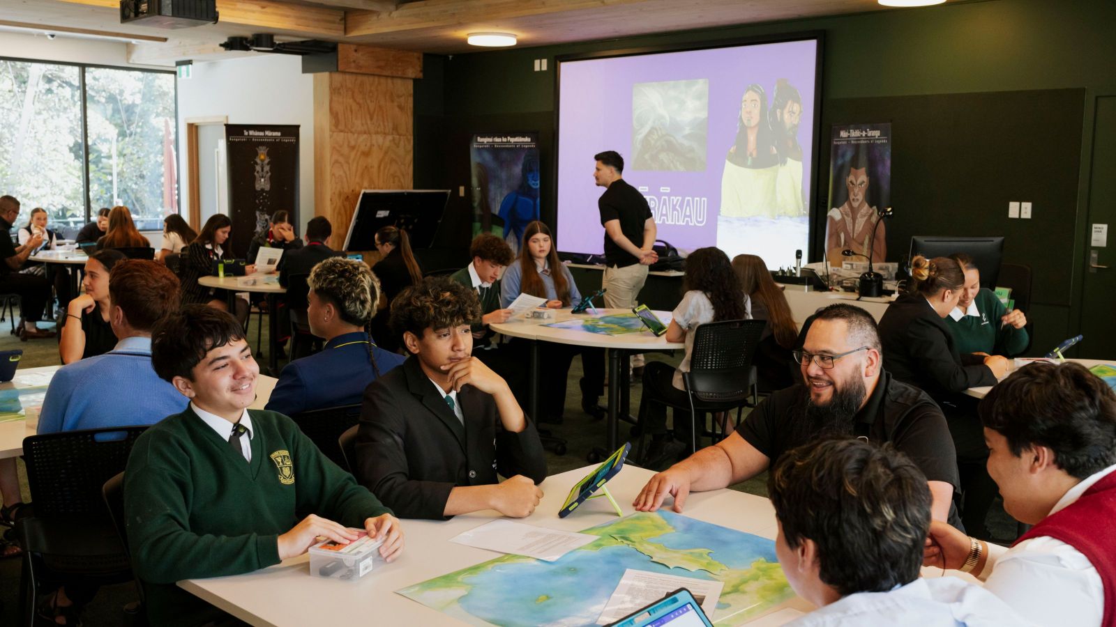 Students grouped around tables with activities on them