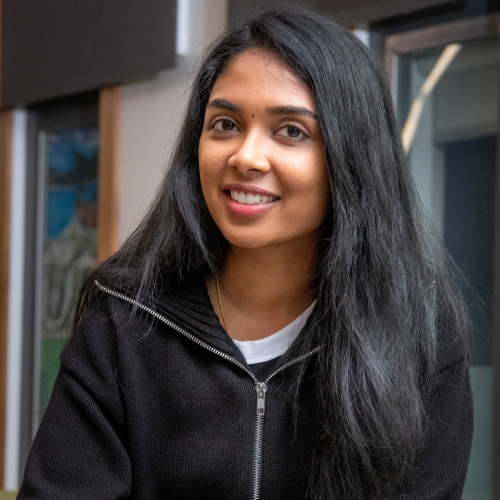 Chemistry PhD student Sri Varshini Murugan pictured smiling in a black zip up hoodie.