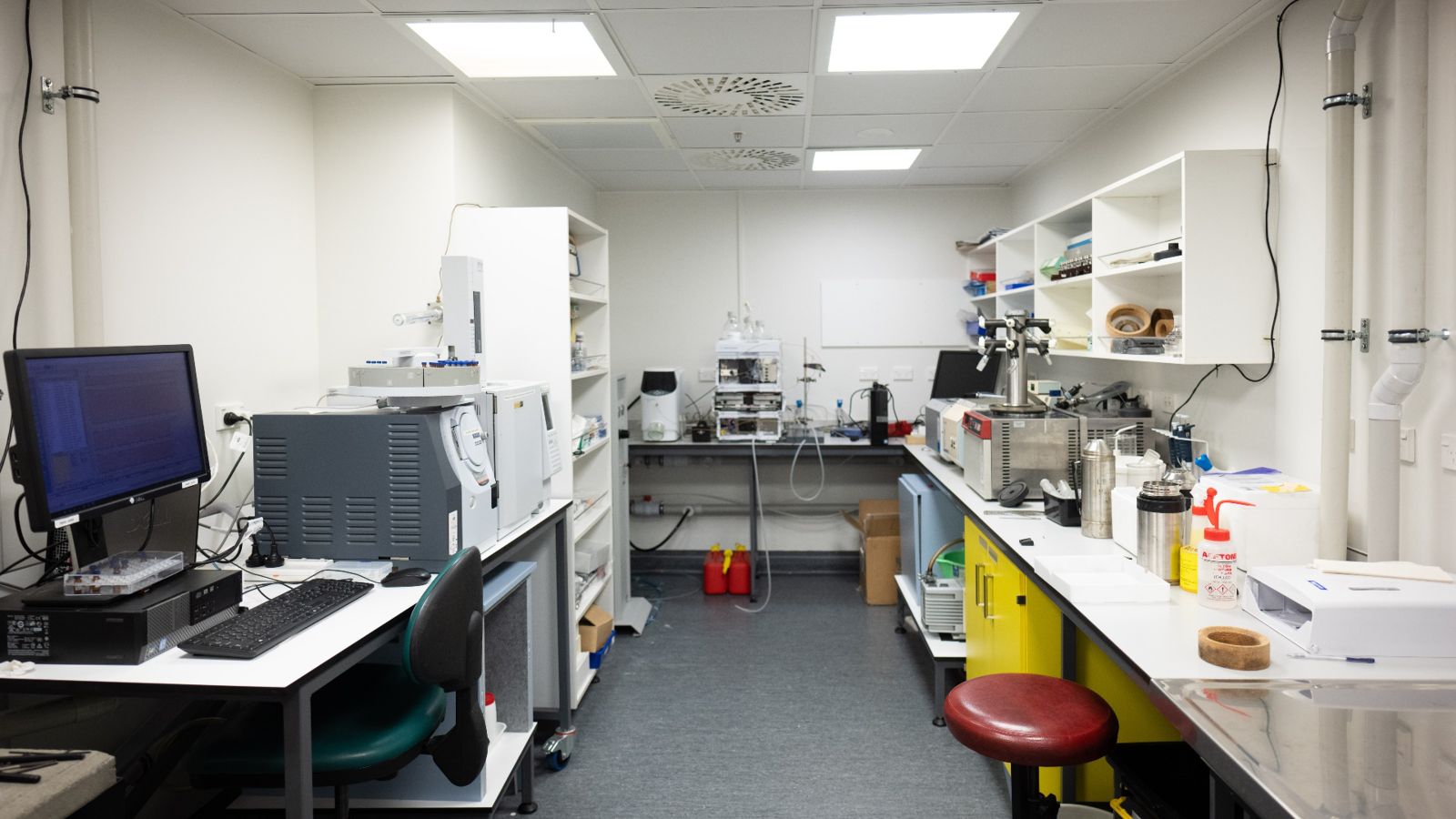 white windowless room with scientific equipment on the benches