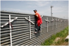 Aspiring migrant from Mexico looks into the US at the Tijuana-San Diego border. 