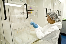 A woman working in a very clean lab.