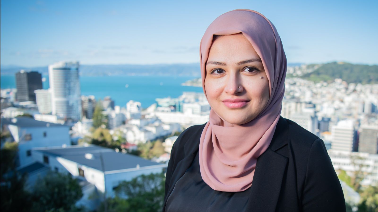 Young woman in hijab with Wellington city in background