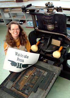 Dr Sydney Shep with an 1813 Stanhope Press, the oldest printing press in New Zealand and still in use