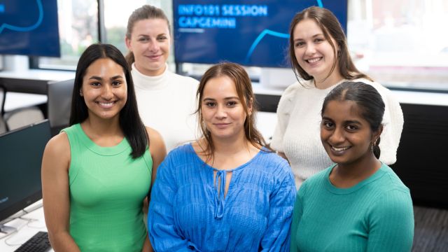 Photograph of two award winners and three Capgemini representatives at award ceremony