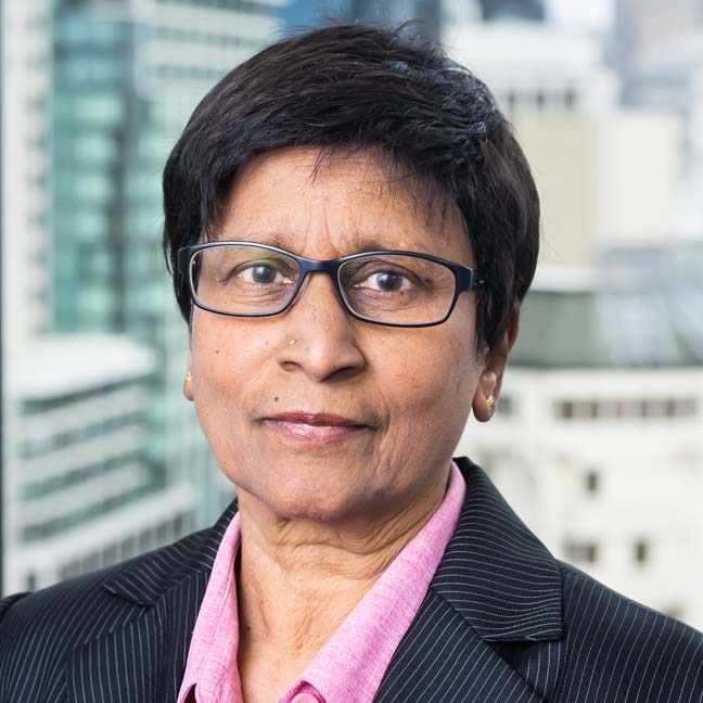 A profile image of Kala Retna, with a blurry city photo in the background.