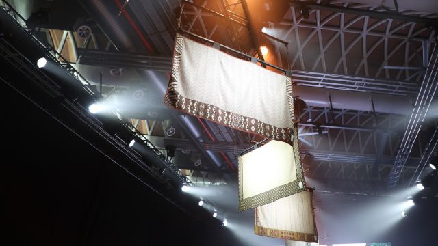 Art installation of woven Maori mats hanging from the ceiling. 